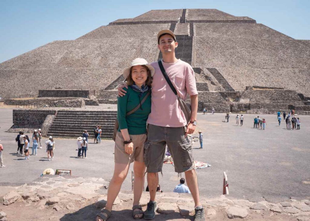 Nomin and Hiro posing for a photo in front of a pyramid.