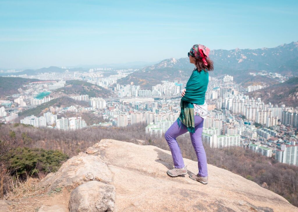 A lady from Moldova looking a landscape form the top of the mountain in South Korea.